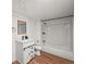 Bathroom featuring a bathtub, toilet, sink, mirror, and wood-look flooring at 3881 S Bahama St, Aurora, CO 80013
