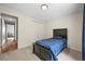 This bedroom has a black bed and is carpeted at 3881 S Bahama St, Aurora, CO 80013