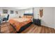 Cozy bedroom with wood floors, large window, stylish decor, and side table at 3881 S Bahama St, Aurora, CO 80013