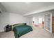 Bedroom with neutral carpet, a closet, bedside tables, and doors leading to other rooms at 3881 S Bahama St, Aurora, CO 80013
