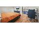 View of a stylish bedroom with wood floors, TV, and a desk in the background at 3881 S Bahama St, Aurora, CO 80013