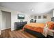 Spacious bedroom featuring wood floors, mounted TV, and tastefully decorated walls at 3881 S Bahama St, Aurora, CO 80013