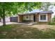 A charming one-story brick home features a front porch and an attached two-car garage at 3881 S Bahama St, Aurora, CO 80013
