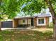 Charming single-story brick house featuring a front porch and attached two-car garage at 3881 S Bahama St, Aurora, CO 80013