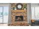 Close-up of a brick fireplace featuring a mantel, round mirror, and decorative accents at 3881 S Bahama St, Aurora, CO 80013