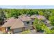 This aerial view showcases the home's roof, garages, and surrounding mature trees at 6375 S Jackson St, Centennial, CO 80121