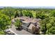 This aerial view showcases the home's roof, garages, and surrounding mature trees at 6375 S Jackson St, Centennial, CO 80121