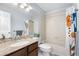Full bathroom with a shower and bathtub combination and a granite countertop sink at 6375 S Jackson St, Centennial, CO 80121