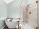 Modern bathroom featuring a soaking tub and glass-enclosed shower with tiled walls at 6375 S Jackson St, Centennial, CO 80121