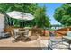 Outdoor deck with a dining table set and patio umbrella at 6375 S Jackson St, Centennial, CO 80121