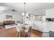 Cozy dining area with modern lighting and a view into the living room at 6375 S Jackson St, Centennial, CO 80121