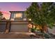 Inviting townhouse with a two-car garage, brick accents, and mature landscaping at 6375 S Jackson St, Centennial, CO 80121