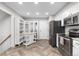 Bright kitchen with white cabinetry, herringbone floors, and a center island for additional workspace at 6375 S Jackson St, Centennial, CO 80121