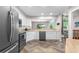 Modern kitchen with stainless steel appliances and a view into the living room at 6375 S Jackson St, Centennial, CO 80121