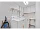 Functional laundry room with white cabinets and modern washer and dryer at 6375 S Jackson St, Centennial, CO 80121