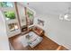 Living room with a fireplace, hardwood floors, many large windows, and a vaulted ceiling at 6375 S Jackson St, Centennial, CO 80121