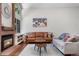 Bright living room with a brick fireplace and comfortable seating arrangement at 6375 S Jackson St, Centennial, CO 80121