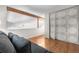 Open-concept living area with hardwood floors and exposed wooden beams at 6375 S Jackson St, Centennial, CO 80121