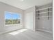 Bright bedroom offers a large window with a neighborhood view and convenient built-in shelving at 1245 Utica St # 104, Denver, CO 80204