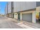 View of home's garages with painted doors, offering secure parking and additional storage at 1245 Utica St # 104, Denver, CO 80204