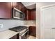 Gourmet kitchen features stainless appliances, modern backsplash, and solid countertops at 1245 Utica St # 104, Denver, CO 80204
