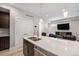 A modern kitchen offers a large island with quartz countertops and stainless steel appliances at 1245 Utica St # 104, Denver, CO 80204