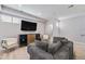 Cozy den offers a relaxing retreat with hardwood floors, media center, and stylish furnishings at 1245 Utica St # 104, Denver, CO 80204
