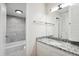 Updated bathroom features granite countertop, white cabinets, tub and shower, new lighting, and new flooring at 955 Eudora St # 505E, Denver, CO 80220
