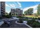 A community courtyard features a fountain, flower beds and mature trees at 955 Eudora St # 505E, Denver, CO 80220