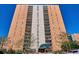 View of a brick apartment building with multiple balconies on a clear day with trees on the ground at 955 Eudora St # 505E, Denver, CO 80220