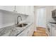 Well-maintained kitchen boasts granite countertops, white cabinets, new flooring, and stainless steel faucet at 955 Eudora St # 505E, Denver, CO 80220