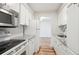 Clean kitchen offers white cabinets, granite countertops, stainless steel microwave, and new flooring at 955 Eudora St # 505E, Denver, CO 80220