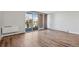Sunlit living room features hardwood floors, sliding doors to the balcony, and neutral paint throughout at 955 Eudora St # 505E, Denver, CO 80220