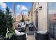 Inviting balcony with comfortable seating, stylish cushions, and lush greenery, perfect for outdoor relaxation at 150 S Madison St # 303, Denver, CO 80209