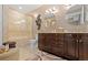 Elegant bathroom with double vanities, decorative mirrors, and a glass-enclosed shower and soaking tub at 150 S Madison St # 303, Denver, CO 80209