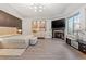 Bright and airy bedroom with fireplace, modern chandelier, and large windows at 150 S Madison St # 303, Denver, CO 80209