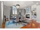 Elegant dining room featuring fireplace, modern chandelier, and large window at 150 S Madison St # 303, Denver, CO 80209