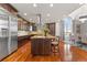 Large kitchen featuring an island with seating, granite countertops and hardwood floors at 150 S Madison St # 303, Denver, CO 80209