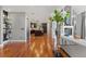 Open-concept living space leading to kitchen, featuring hardwood floors and a fireplace at 150 S Madison St # 303, Denver, CO 80209