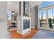 Living space showcasing a fireplace, large windows, and elegant dining area at 150 S Madison St # 303, Denver, CO 80209