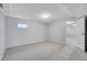 Neutral carpeted basement bedroom with light-colored walls, electrical outlets, and a doorway to the main basement area at 11247 Wyandot St, Denver, CO 80234