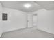 Finished basement area with neutral carpet, painted white walls and a partially open doorway into a larger space at 11247 Wyandot St, Denver, CO 80234