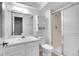 Bathroom featuring a white vanity, toilet and standing shower with glass doors at 11247 Wyandot St, Denver, CO 80234