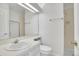 Bright bathroom with a clean white sink, toilet, and shower with glass door at 11247 Wyandot St, Denver, CO 80234