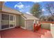 View of a spacious red deck with brick accents, a sliding glass door, and outdoor lighting at 11247 Wyandot St, Denver, CO 80234