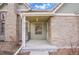 Inviting front porch with brick accents and covered entry at 11247 Wyandot St, Denver, CO 80234