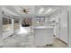 Well-lit kitchen with white cabinets, an island, and a view to the backyard at 11247 Wyandot St, Denver, CO 80234