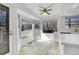 Bright kitchen nook with large windows, tiled floor, and white cabinets at 11247 Wyandot St, Denver, CO 80234