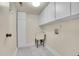 Laundry room including a wash basin with cabinetry and utility shelving at 11247 Wyandot St, Denver, CO 80234