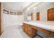 Bathroom with a tub, a toilet, and a vanity with ample counter space under a mirror at 14562 W 3Rd Ave, Golden, CO 80401